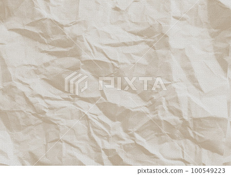 Crumpled light beige paper. The old sheet is crumpled. 100549223