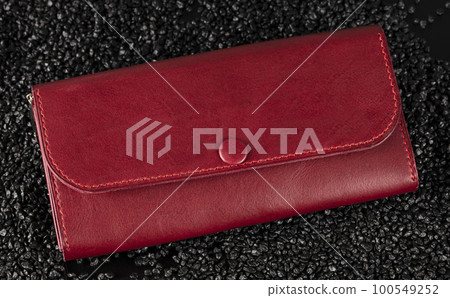 Leather red purse close-up on a black background. Leather red purse close-up on a black background. 100549252