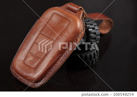 Leather case for car keys on a black background. Leather case for car keys on a black background. 100549254