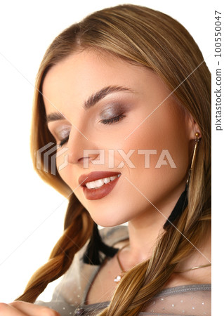 Portrait of beautiful woman with evening makeup and hair with braids Portrait of beautiful woman with evening makeup and hair with braids 100550047