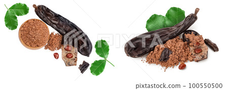 Carob pod and powder in wooden scoop isolated on white background . Top view. Flat lay Carob pod and powder in wooden scoop isolated on white background . Top view. Flat lay 100550500
