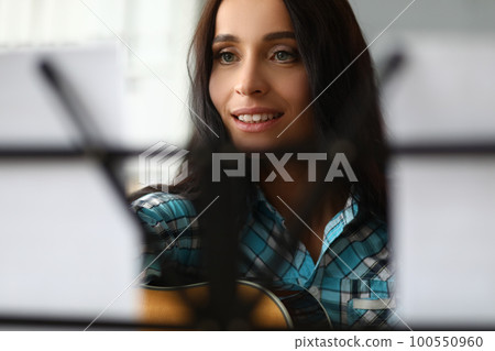 Portrait of woman playing music notes closeup 100550960