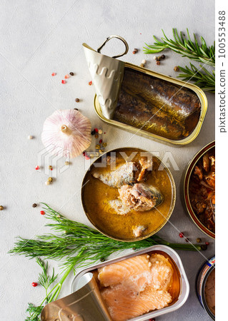 Open tin cans with canned fish 100553488