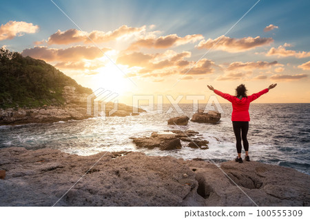 Woman on Rocky Coast in a park at Touristic Town, Sorrento, Italy 100555309