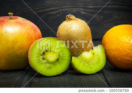 Set of fruits on a vintage black table for composing diet and supply of vitamins Set of fruits on a vintage black table for composing diet and supply of vitamins 100556780
