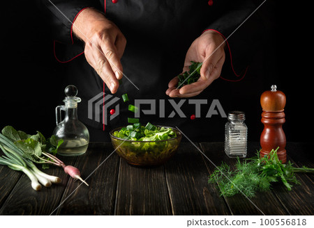 Delicious salad for breakfast. Chef preparing food from fresh vegetables in the kitchen Delicious salad for breakfast. Chef preparing food from fresh vegetables in the kitchen 100556818