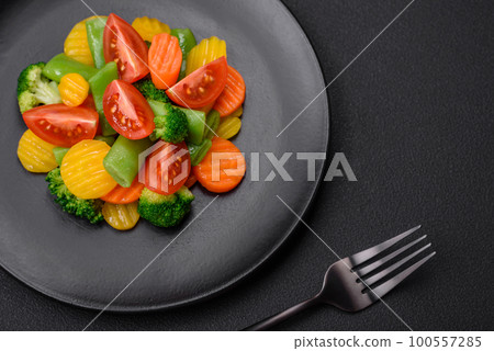 Salad of fresh and steamed vegetables cherry tomatoes, broccoli and carrots Salad of fresh and steamed vegetables cherry tomatoes, broccoli and carrots 100557285