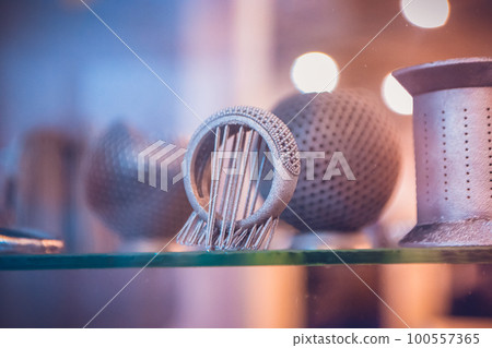 Object printed from metal powder on metal 3d printer.Object printed in laser sintering machine. Modern 3D printer printing from metal powder. Progressive additive DMLS, SLM, SLS 3d printing technology 100557365
