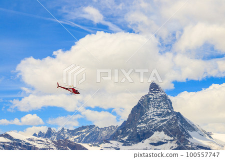 Helicopter flying over snowy Matterhorn peak, Switzerland Helicopter flying over snowy Matterhorn peak, Switzerland 100557747