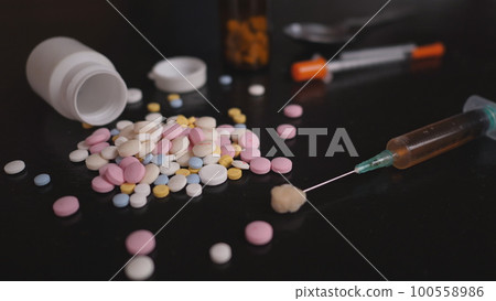 addict's table pills and injection on the black table addict's table pills and injection on the black table 100558986
