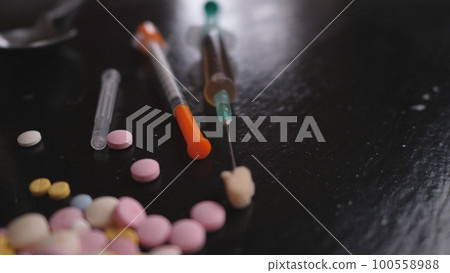 addict's table pills and injection on the black table addict's table pills and injection on the black table 100558988
