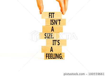 Fit, size or feeling symbol. Concept words Fit is not a size it is a feeling on wooden blocks. Beautiful white background. Copy space. Businessman hand. Motivational fit size or feeling concept. Fit, size or feeling symbol. Concept words Fit is not a size it is a feeling on wooden blocks. Beautiful white background. Copy space. Businessman hand. Motivational fit size or feeling concept. 100559661