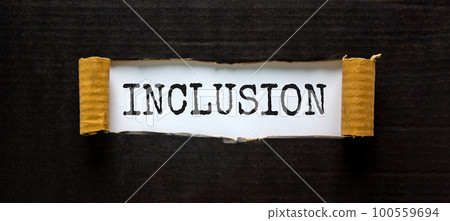 Belonging and inclusion symbol. The word 'inclusion' appearing behind torn black paper. Beautiful black background. Business, inclusion and belonging concept. Copy space. 100559694