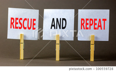 Rescue and repeat symbol. Concept words Rescue and repeat on white paper on wooden clothespin on a beautiful grey table grey background. Business rescue and repeat concept. Copy space. 100559728