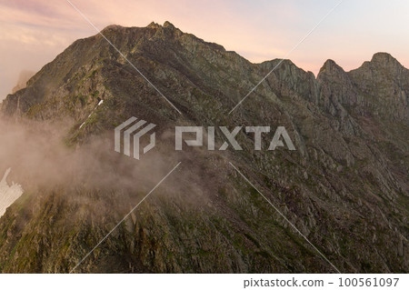 Mt. Okuhotaka and Gendarme at sunrise seen from Mt. Karasawa in the Northern Alps Mt. Okuhotaka and Gendarme at sunrise seen from Mt. Karasawa in the Northern Alps 100561097
