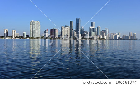 Miami Florida skyline reflected on calm Biscayne Bay in morning light. 100561374