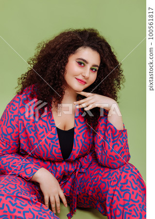 A young woman with a plus size figure with an Afro hairstyle A young woman with a plus size figure with an Afro hairstyle 100561817