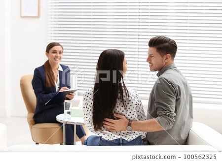 Professional psychologist working with couple in office 100562325