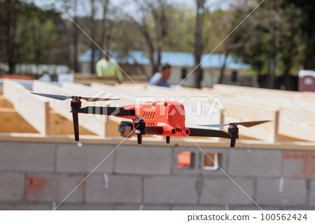 Professional engineer architect controls construction process with drone Professional engineer architect controls construction process with drone 100562424