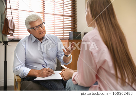 Professional psychotherapist working with patient in office Professional psychotherapist working with patient in office 100562493
