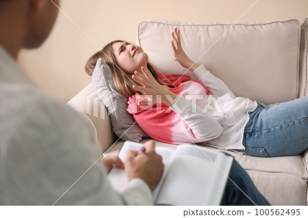 Professional psychotherapist working with patient in office 100562495