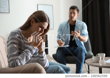 Professional psychotherapist working with patient in office 100562500
