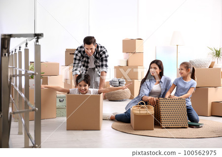 Happy family having fun while unpacking moving boxes at their new home Happy family having fun while unpacking moving boxes at their new home 100562975