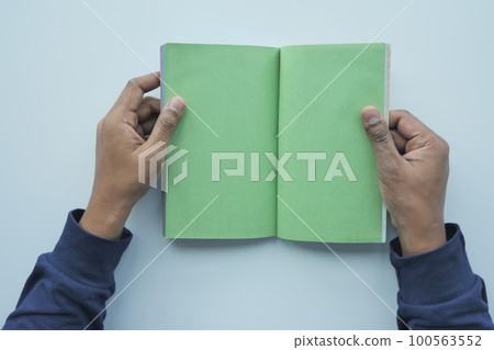 top view of an's hand turning a pager of a diary top view of an's hand turning a pager of a diary 100563552