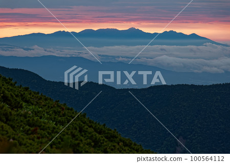 Yatsugatake at dawn seen from the ridgeline of Mt. Nishihotaka in the Northern Alps Yatsugatake at dawn seen from the ridgeline of Mt. Nishihotaka in the Northern Alps 100564112