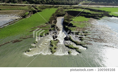 aerial view of underground sinkhole waterfall as water flows aerial view of underground sinkhole waterfall as water flows 100569108