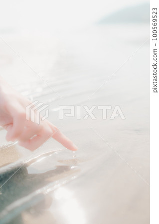 Photo of a woman standing on the beach 100569523
