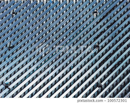 Never ending view of solar panels stacked in lines on the rooftop Never ending view of solar panels stacked in lines on the rooftop 100572301