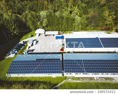 Solar panels on the rood of industrial buildings on a secluded sunny location Solar panels on the rood of industrial buildings on a secluded sunny location 100572413