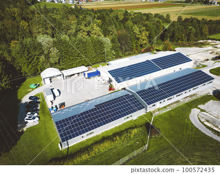 Industrial area, roof tops of the buildings covered with solar panels 100572435