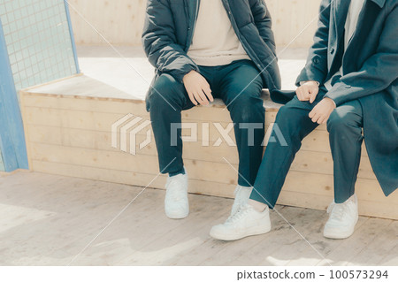 Photo of male college students talking in the park 100573294