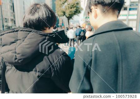Photo of a male college student walking in the city 100573928