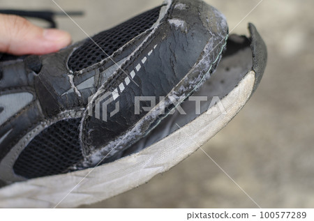 close up of broken black shoes 100577289