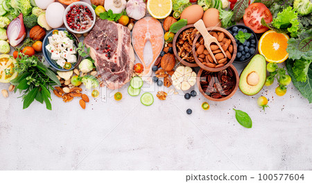 Ketogenic low carbs diet concept. Ingredients for healthy foods selection set up on white concrete background. Ketogenic low carbs diet concept. Ingredients for healthy foods selection set up on white concrete background. 100577604