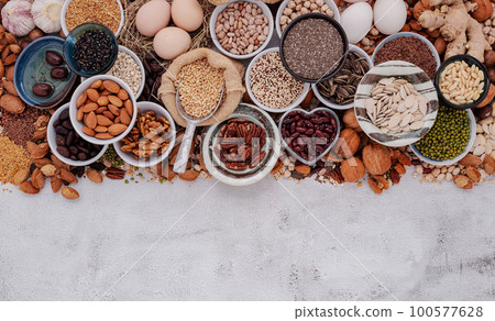 Ingredients for the healthy foods selection. The concept of superfoods set up on white shabby concrete background with copy space. 100577628