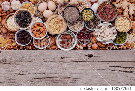 Ingredients for the healthy foods selection in ceramic bowl. The concept of superfoods set up on white shabby wooden background with copy space. 100577631