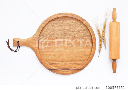 Empty wooden pizza platter set up on isolated on white background. Pizza tray on on white background flat lay and copy space... Empty wooden pizza platter set up on isolated on white background. Pizza tray on on white background flat lay and copy space... 100577651