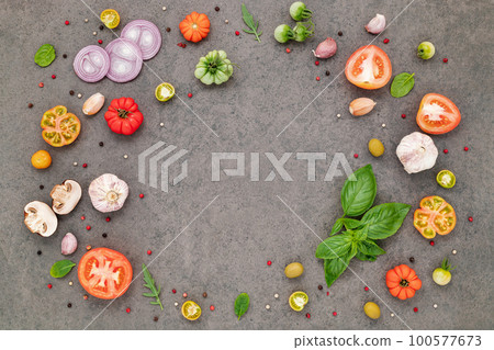 The ingredients for homemade pizza set up on dark stone background. The ingredients for homemade pizza set up on dark stone background. 100577673