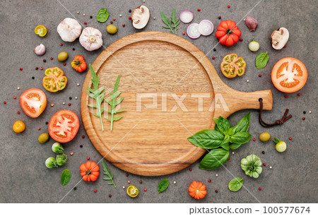 The ingredients for homemade pizza set up on dark stone background. The ingredients for homemade pizza set up on dark stone background. 100577674