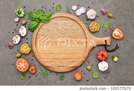 The ingredients for homemade pizza set up on dark stone background. The ingredients for homemade pizza set up on dark stone background. 100577678
