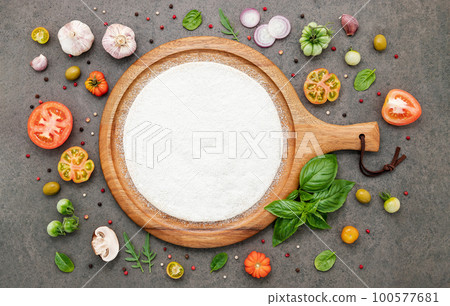 The ingredients for homemade pizza set up on dark stone background. The ingredients for homemade pizza set up on dark stone background. 100577681