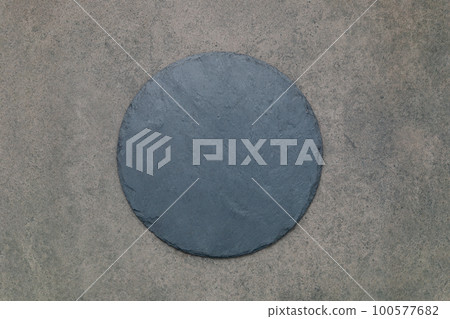 Empty pizza platter for homemade baking set up on dark concrete. Food recipe concept on dark stone background texture with copy space. Empty pizza platter for homemade baking set up on dark concrete. Food recipe concept on dark stone background texture with copy space. 100577682