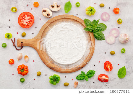 The ingredients for homemade pizza set up on white concrete background. The ingredients for homemade pizza set up on white concrete background. 100577911