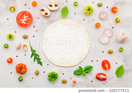 The ingredients for homemade pizza set up on white concrete background. 100577913
