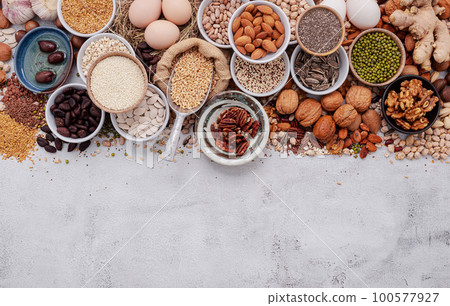 Ingredients for the healthy foods selection. The concept of superfoods set up on white shabby concrete background with copy space. 100577927