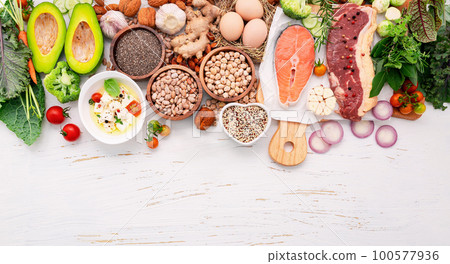 Ketogenic low carbs diet concept. Ingredients for healthy foods selection set up on white wooden background. Ketogenic low carbs diet concept. Ingredients for healthy foods selection set up on white wooden background. 100577936